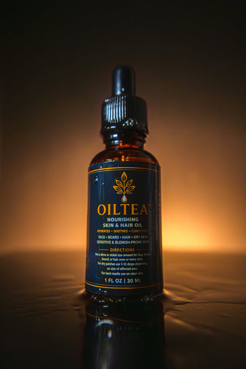 OILTEA bottle backlit by a warm golden glow