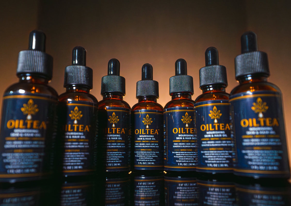 Lineup of seven OILTEA bottles side by side